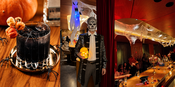Ein dunkler Cocktail mit Plastikspinnen verkleidet, zusammen mit einem Mitarbeiter als Totenkopf geschminkt in der Lvdwig Bar